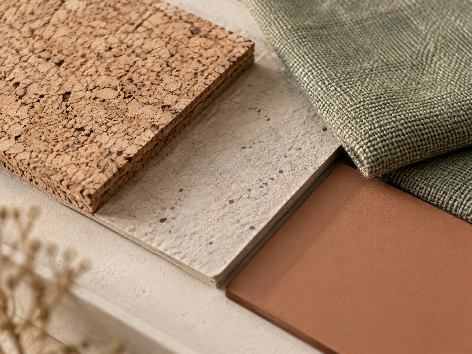 Cork, recycled board, natural fibre and coated sample swatches arranged on a studio bench